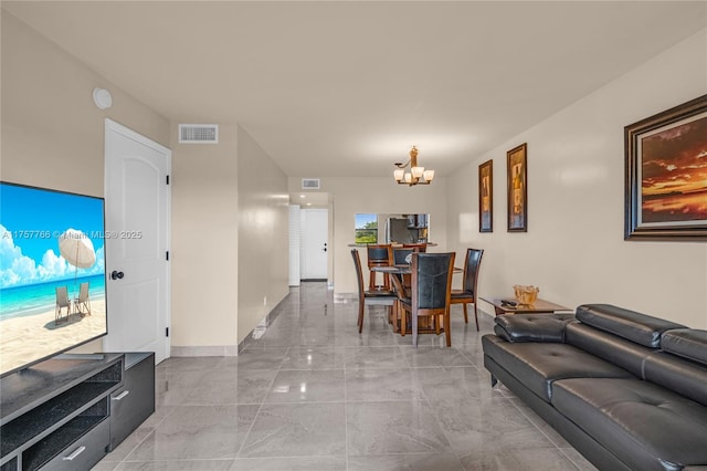 living room featuring marble finish floor, visible vents, a notable chandelier, and baseboards