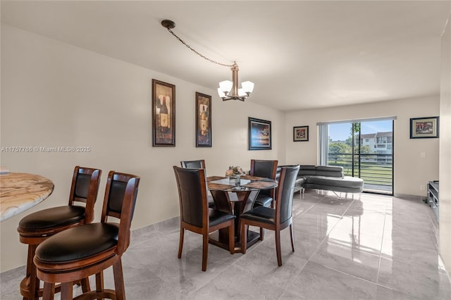 dining room with marble finish floor and a chandelier