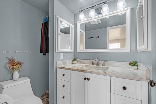 bathroom featuring toilet and vanity