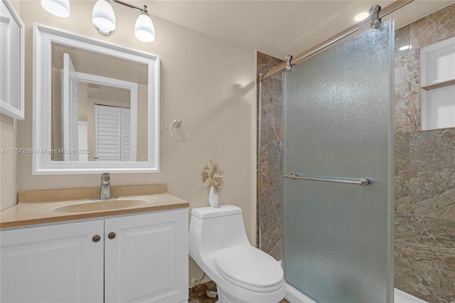 full bathroom featuring a stall shower, vanity, and toilet