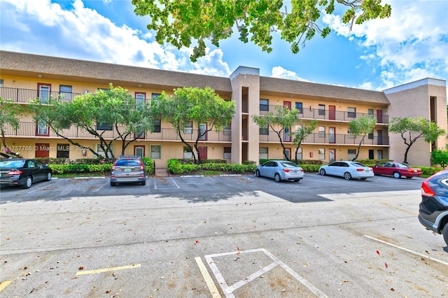 view of building exterior with uncovered parking