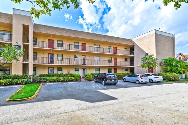 view of building exterior with uncovered parking