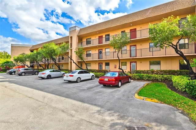 view of building exterior featuring uncovered parking