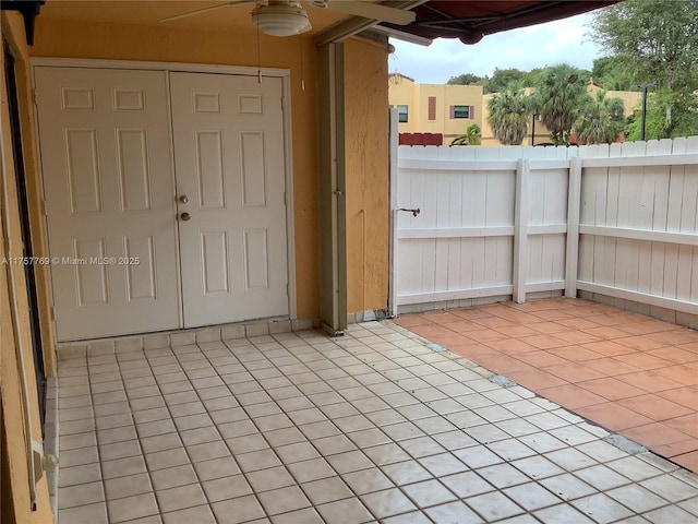 view of patio with fence and ceiling fan