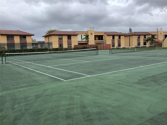 view of sport court featuring fence