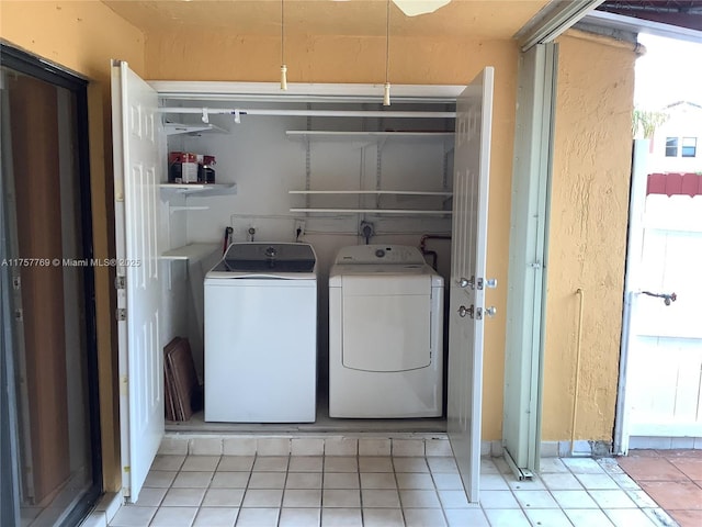 laundry area featuring washing machine and dryer, laundry area, and light tile patterned floors