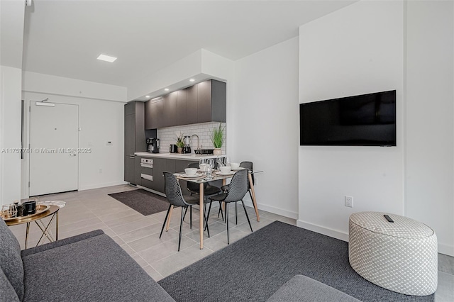 dining area featuring baseboards and light tile patterned flooring