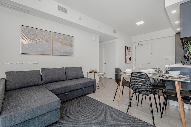 living area with light tile patterned floors and visible vents