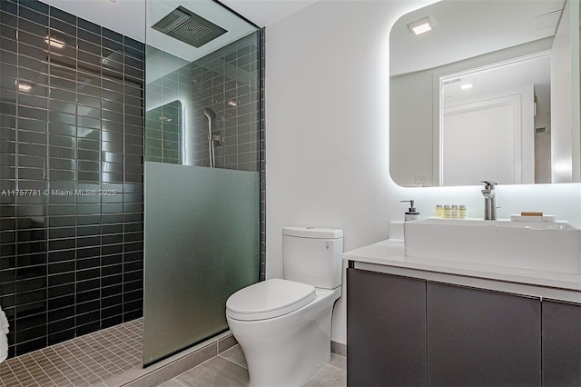 full bath with toilet, tile patterned floors, walk in shower, and vanity