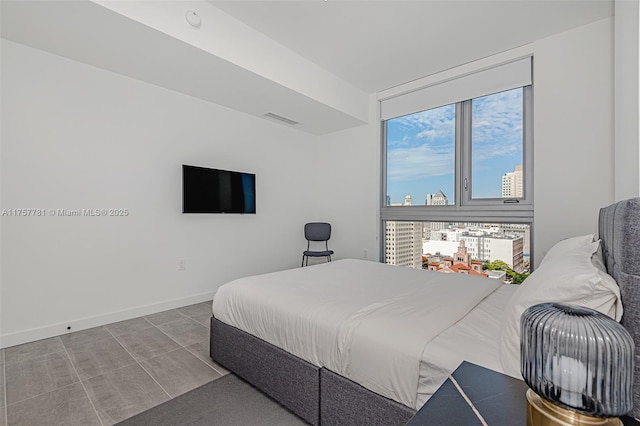 bedroom featuring visible vents and baseboards