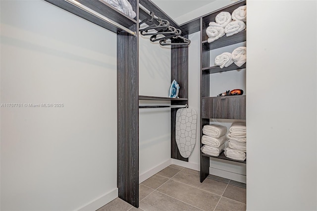 walk in closet featuring tile patterned flooring