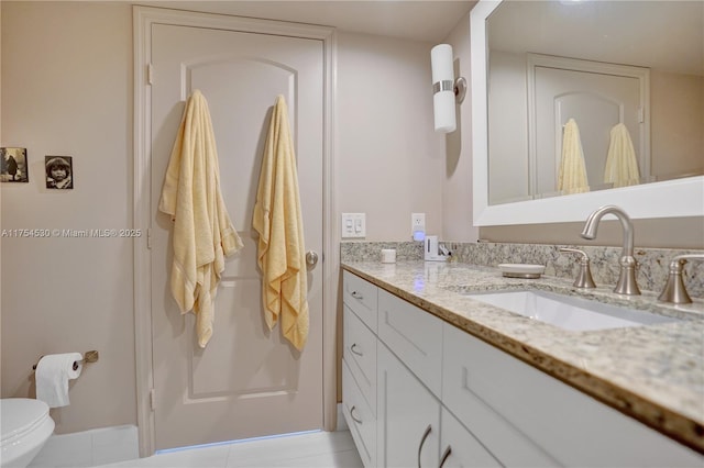 bathroom featuring toilet and vanity