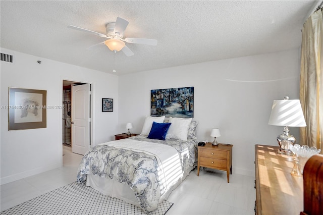 bedroom featuring ceiling fan, baseboards, and a textured ceiling