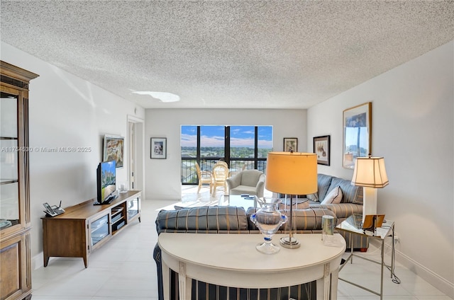 living area featuring a textured ceiling and baseboards