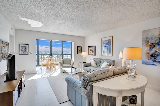 living area with light tile patterned floors and a textured ceiling
