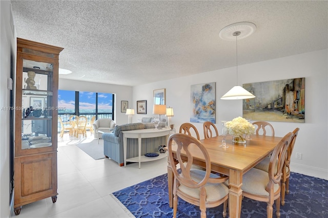 dining area featuring a textured ceiling and baseboards