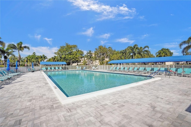 pool featuring a patio and fence