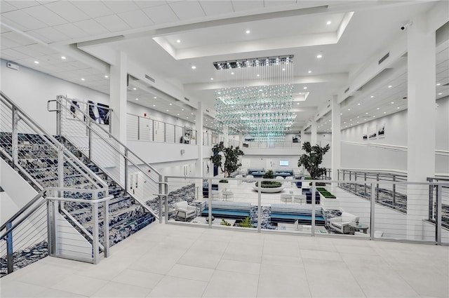 workout area with tile patterned floors, a raised ceiling, visible vents, and recessed lighting