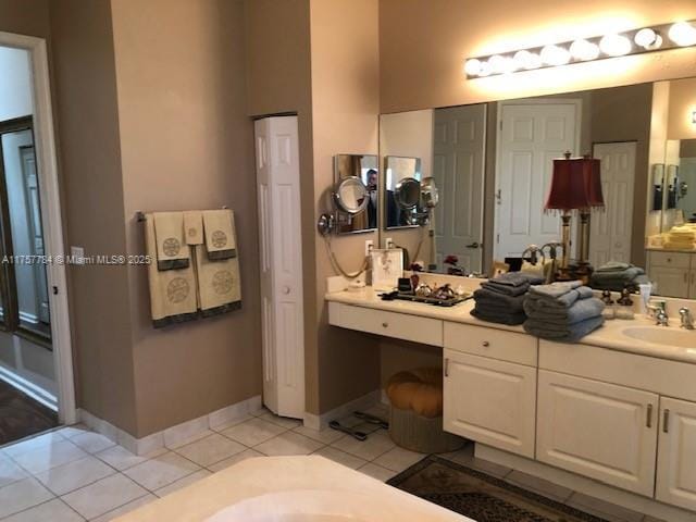 full bathroom with tile patterned flooring, a closet, vanity, and baseboards