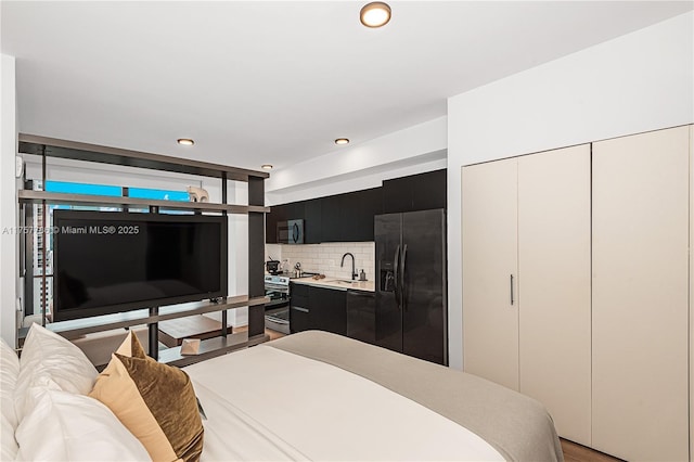 bedroom with fridge with ice dispenser, a sink, and recessed lighting