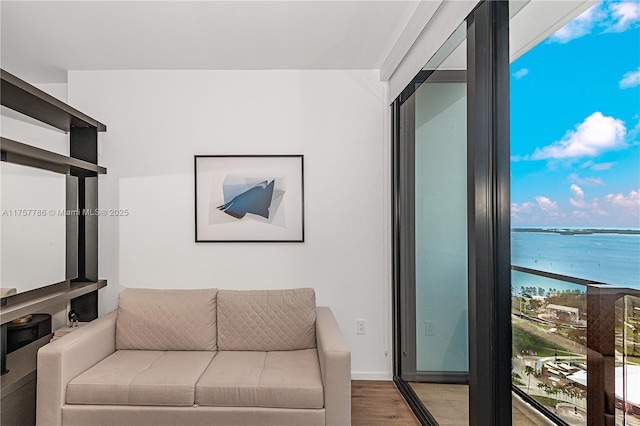 living room with a water view and wood finished floors