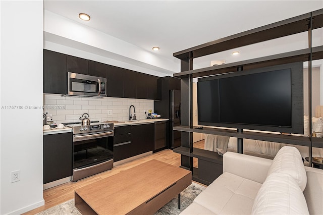 living room with light wood-style floors and recessed lighting