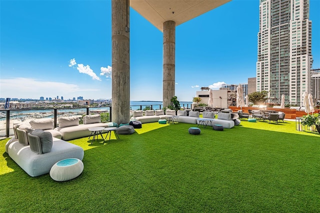 view of yard with a view of city, a water view, and an outdoor hangout area