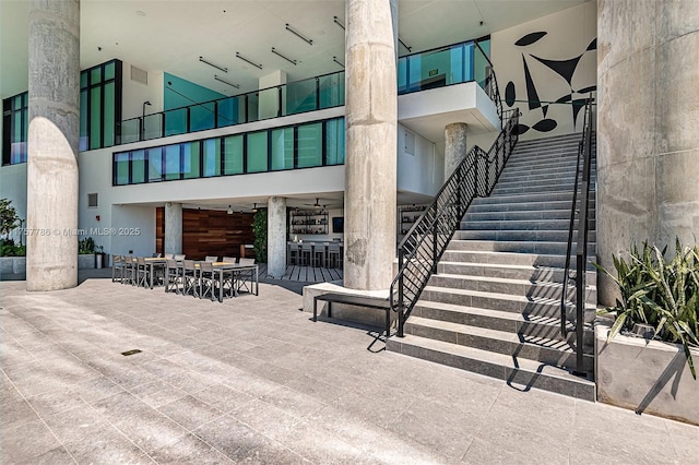 view of patio / terrace with outdoor dining area and stairway