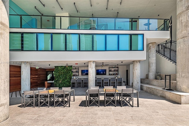 rear view of house with outdoor dry bar, a patio, and outdoor dining space