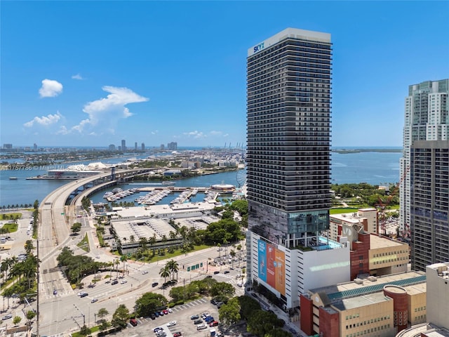 birds eye view of property featuring a water view and a city view