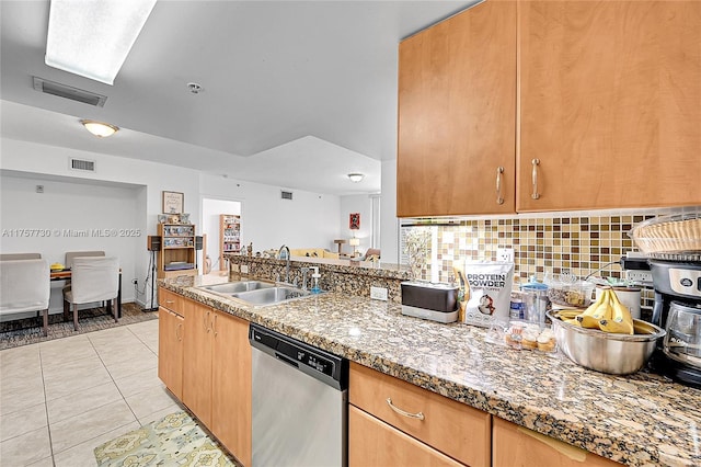 kitchen featuring dishwasher, light tile patterned floors, a sink, and visible vents