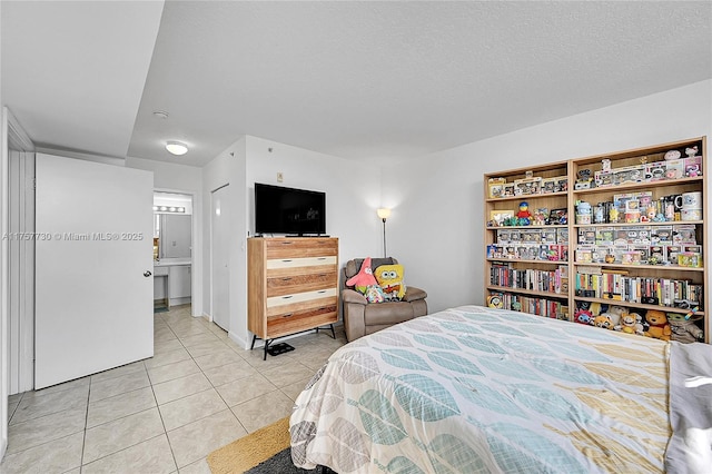 bedroom with light tile patterned floors and a textured ceiling