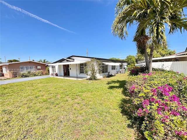 exterior space featuring a front yard and fence