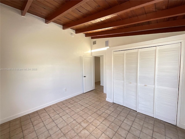 unfurnished bedroom with vaulted ceiling with beams, wooden ceiling, visible vents, baseboards, and a closet