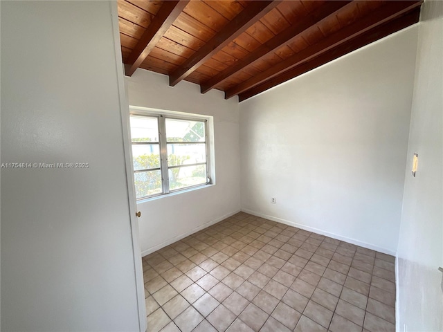 spare room featuring vaulted ceiling with beams, light tile patterned floors, wood ceiling, and baseboards