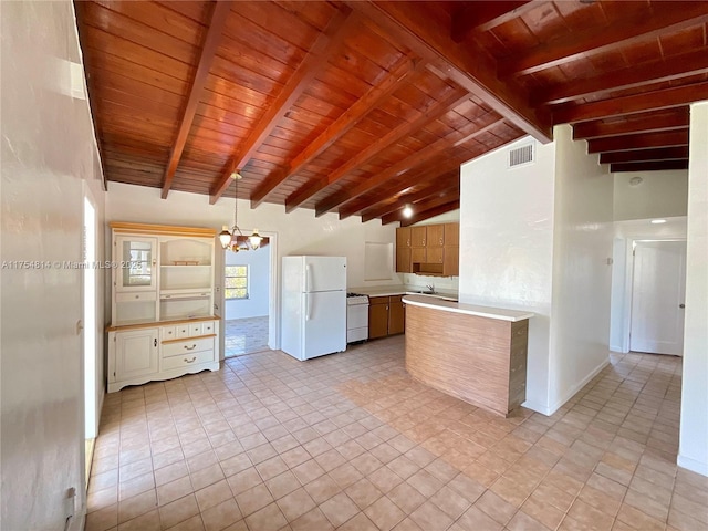 kitchen with vaulted ceiling with beams, wood ceiling, light countertops, freestanding refrigerator, and an inviting chandelier