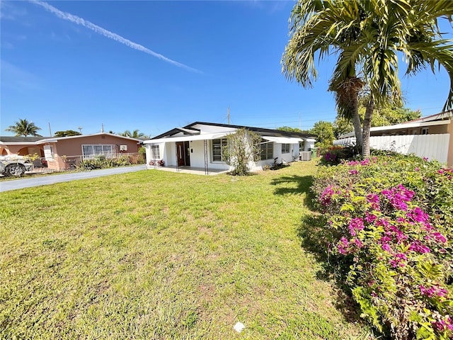 view of front of property with a front yard and fence