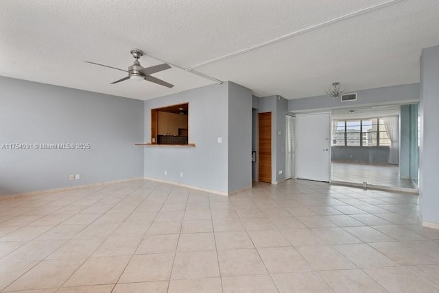 unfurnished room featuring light tile patterned floors, baseboards, visible vents, a ceiling fan, and a textured ceiling