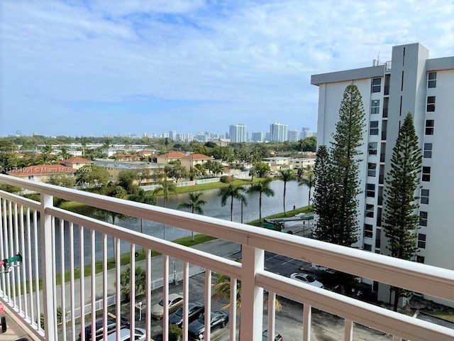 balcony with a water view and a city view