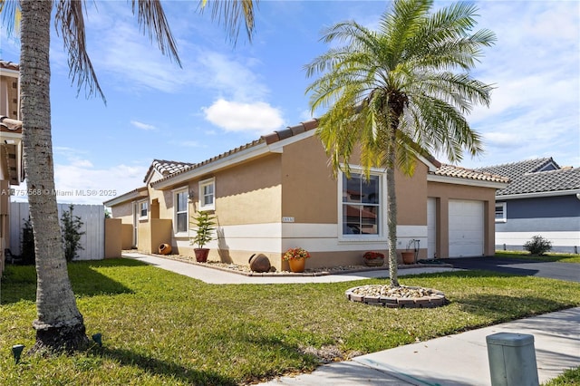 view of property exterior featuring aphalt driveway, an attached garage, fence, a lawn, and stucco siding