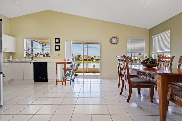 dining space with lofted ceiling and light tile patterned floors