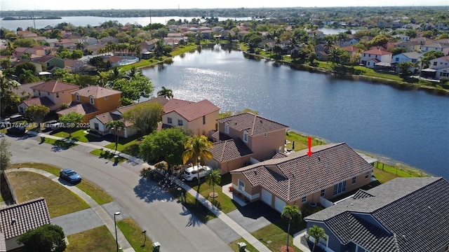 aerial view featuring a residential view and a water view