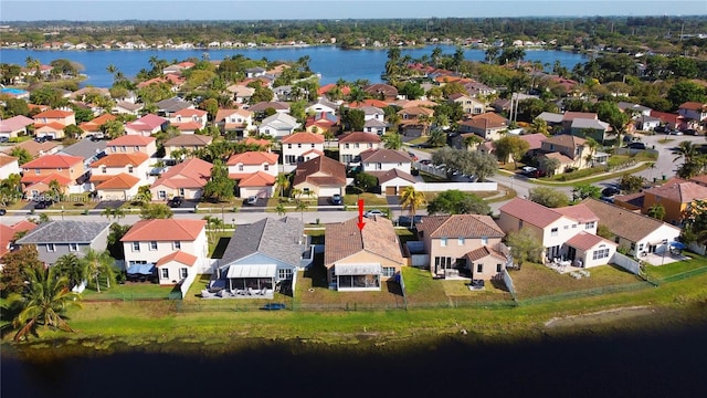 drone / aerial view featuring a residential view and a water view