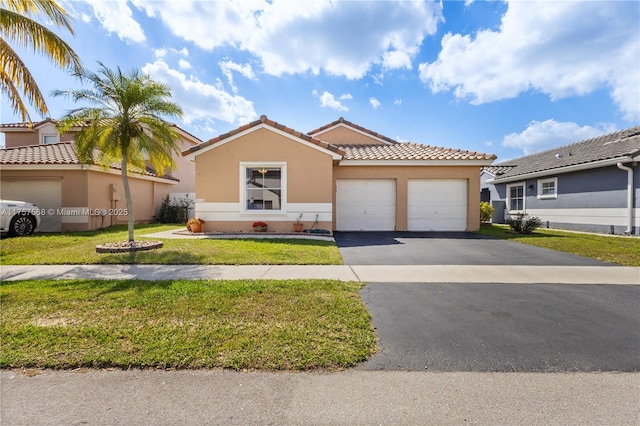 view of front of property with driveway, stucco siding, a tile roof, an attached garage, and a front yard