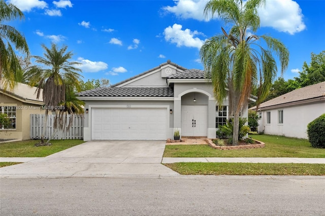 view of front of property featuring a garage, driveway, stucco siding, a tiled roof, and a front yard