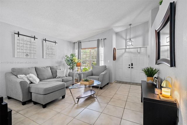 living area with lofted ceiling, light tile patterned floors, and a textured ceiling