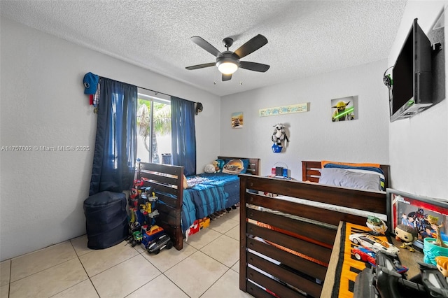 bedroom featuring ceiling fan, a textured ceiling, and light tile patterned floors