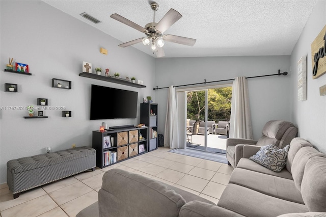 tiled living area with visible vents, vaulted ceiling, a textured ceiling, and ceiling fan