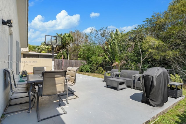 view of patio with grilling area, fence, and outdoor dining area