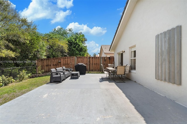 view of patio with a fenced backyard, an outdoor hangout area, and outdoor dining area